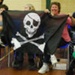 Mrs Diane Taylor with the Skull and Skatebones flag she made for Portsmouth Roller Wenches; 2012; GWL-2022-120-1