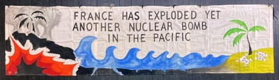 Banner: France Has Exploded Yet Another Nuclear Bomb...; c.1980s-90s; GWL-2024-113-2