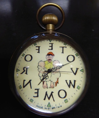 Anti-suffragette clock with depiction of a tired, angry man holding two babies on his knees