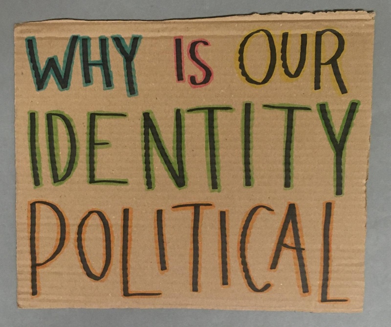 Placard: Why Is Our Identity Political; 2023; GWL-2023-57-9