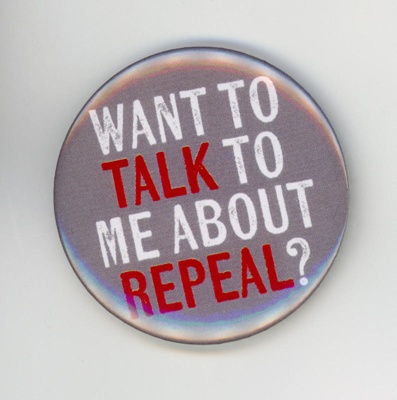 Badge: WANT TO TALK TO ME ABOUT REPEAL?; 2018; GWL-2018-26-1