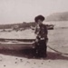 Woman sitting on the back of a boat at Half Moon Bay; 190-; P1503