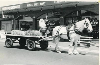 Santa Claus (Graeme Disney) on dray led by Jim Bisset's horse, Silver; 1982; P9004