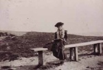 Woman sitting on a seat at Half Moon Bay; 190-; P1512