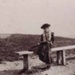 Woman sitting on a seat at Half Moon Bay; 190-; P1512