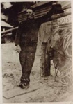 Fred Pearce, son of Ollie Pearce, outside their boatshed at Half Moon Bay; 190-; P1606
