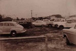 Cars parked at the Dunlop battery manufacturing plant, Sandringham.; Cockburn, David M.; 1956; P0589